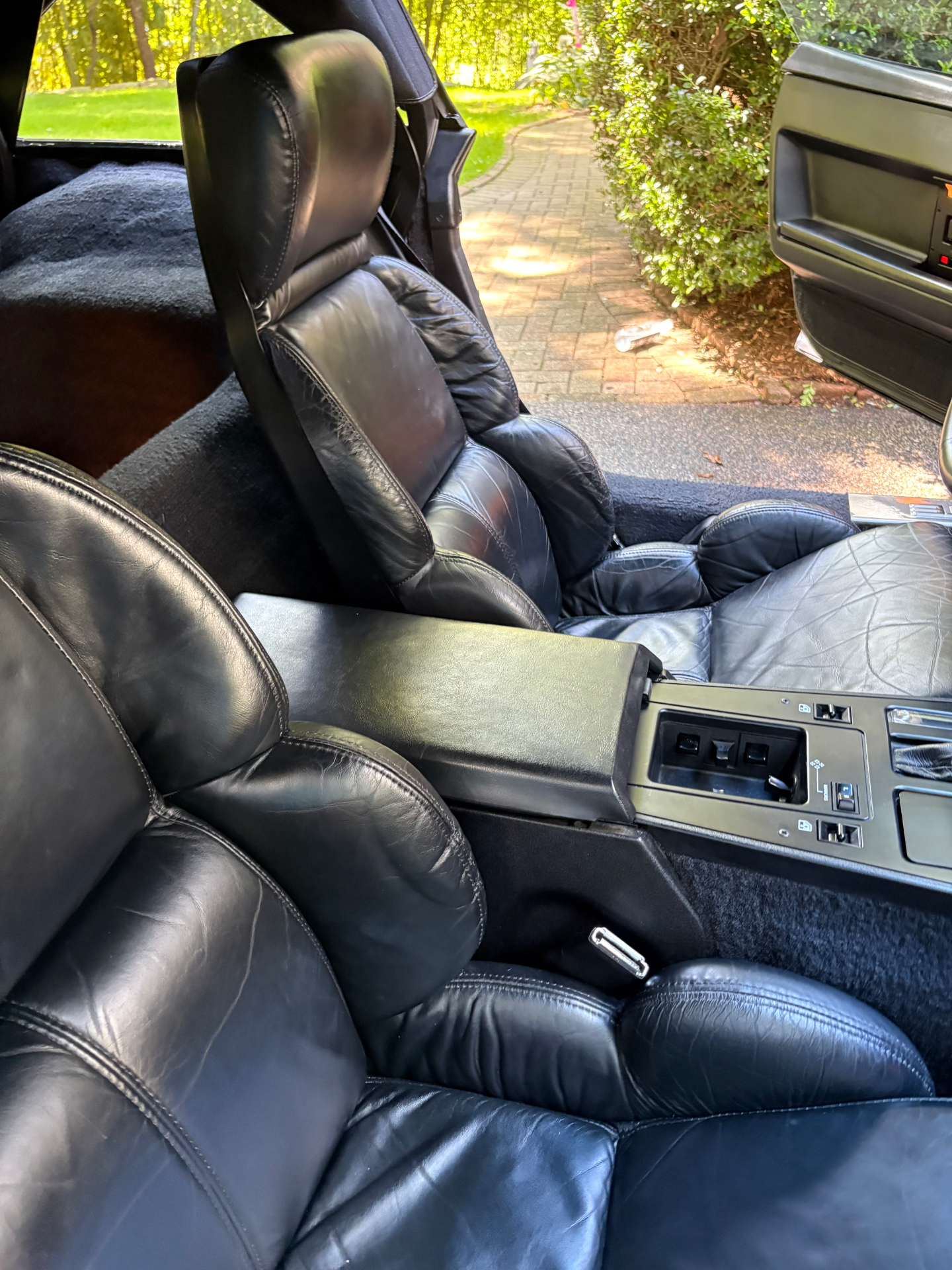Chevrolet Corvette interior with deep-cleaned black leather bucket seats after detailing